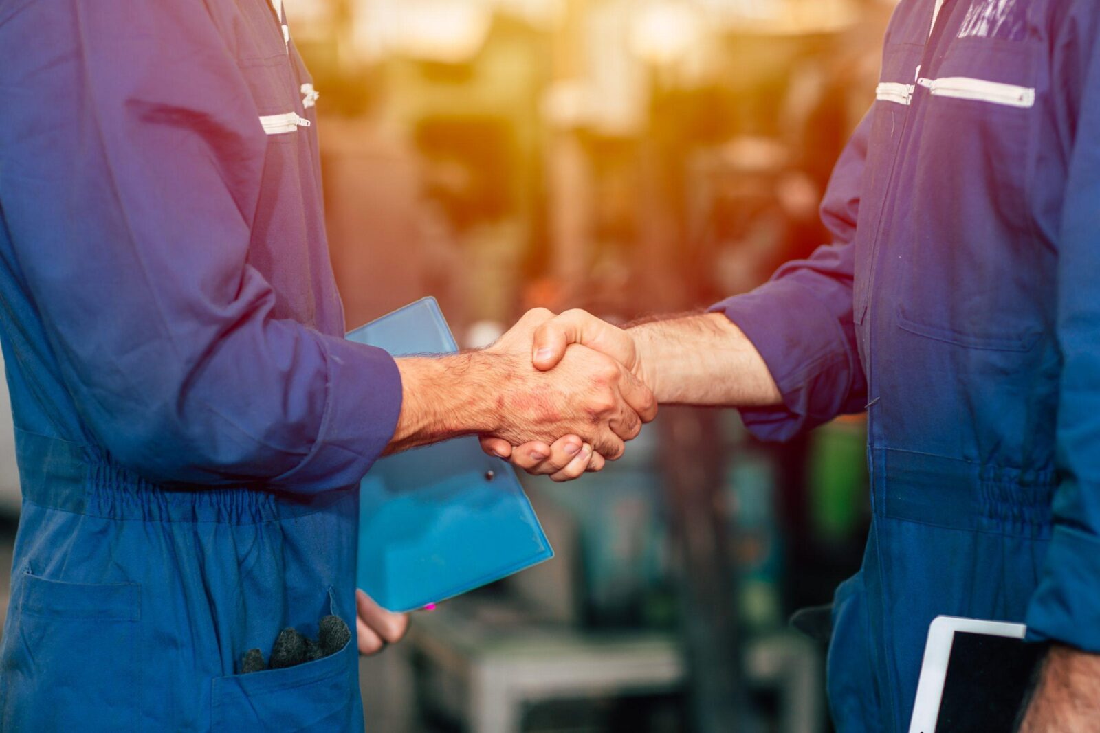 Worker team hand shaking to co-operated the factory engineer work or dealing job done.